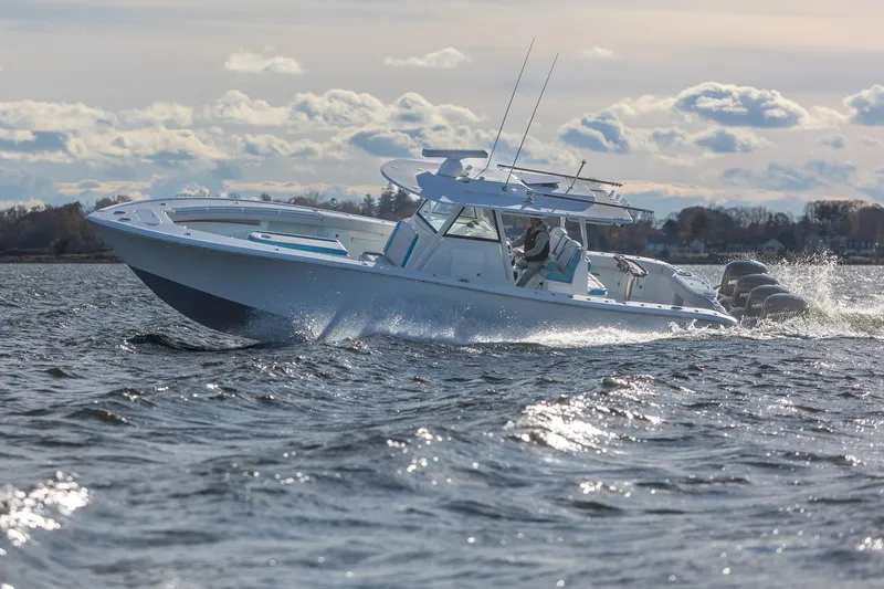 Slide: The Image of 2018 Yellowfin 39 Offshore boat cruising on open water under a cloudy sky. - 53