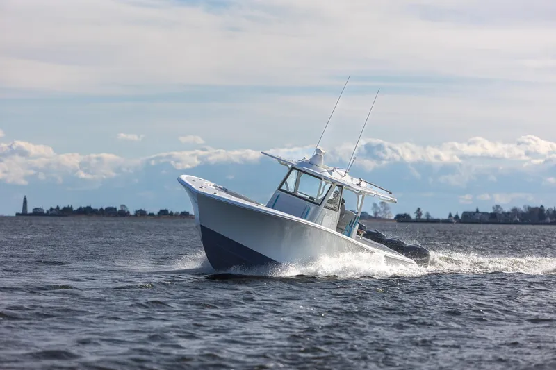 Slide: The Image of 2018 Yellowfin 39 Offshore boat cruising on open water under a cloudy sky. - 55