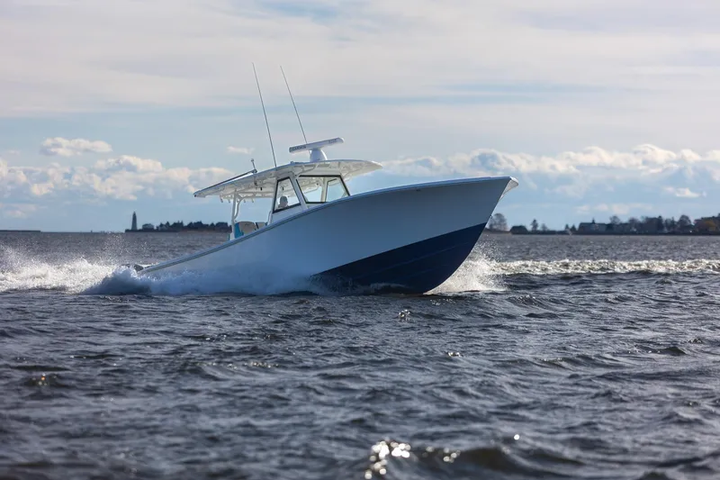 Slide: The Image of 2018 Yellowfin 39 Offshore boat cruising on open water under a clear sky. - 57