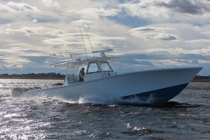 Slide: The Image of 2018 Yellowfin 39 Offshore boat cruising on open water under cloudy skies. - 59