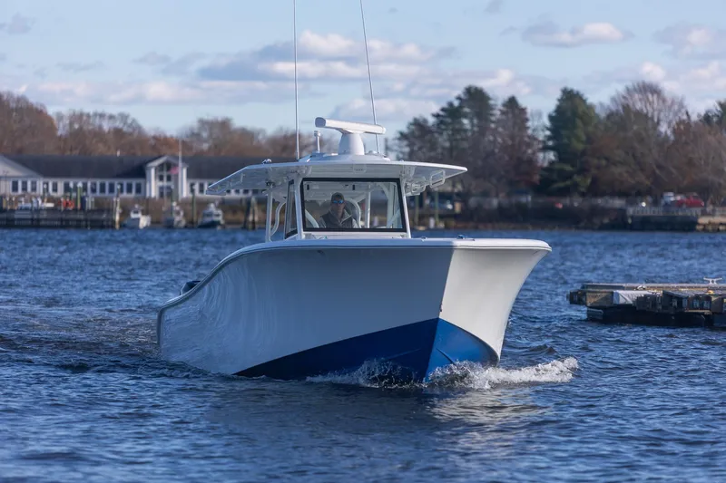 Slide: The Image of 2018 Yellowfin 39 Offshore boat cruising on a calm river near a marina. - 62