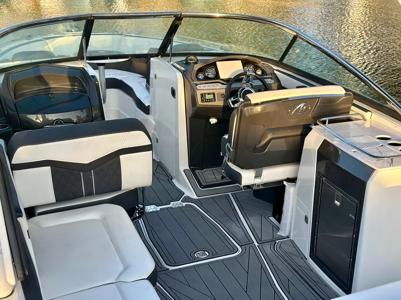 Slide: The Image of 2022 Monterey 275 Super Sport boat interior with sleek seating and modern dashboard design. - 10