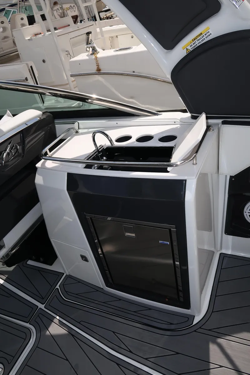Slide: The Image of 2022 Monterey 275 Super Sport boat interior with sleek kitchenette and modern design. - 12