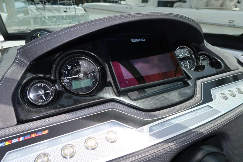 Slide: The Image of Dashboard of 2022 Monterey 275 Super Sport boat with gauges and Simrad display. - 14