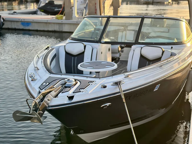 Slide: The Image of 2022 Monterey 275 Super Sport boat docked in marina, featuring sleek design and comfortable seating. - 2