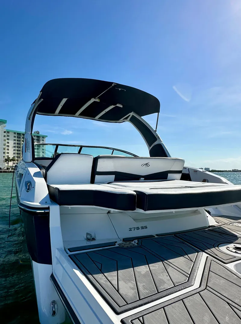 Slide: The Image of 2022 Monterey 275 Super Sport boat docked under clear blue sky. - 3