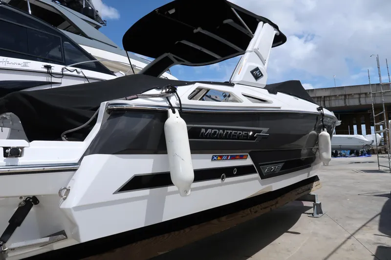 Slide: The Image of 2022 Monterey 275 Super Sport boat docked, featuring sleek design and modern amenities. - 6