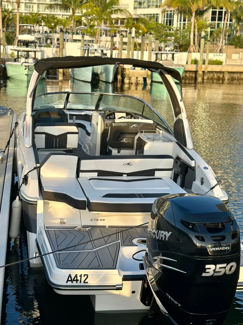Slide: The Image of 2022 Monterey 275 Super Sport boat docked with Mercury 350 engine, in a marina setting. - 8