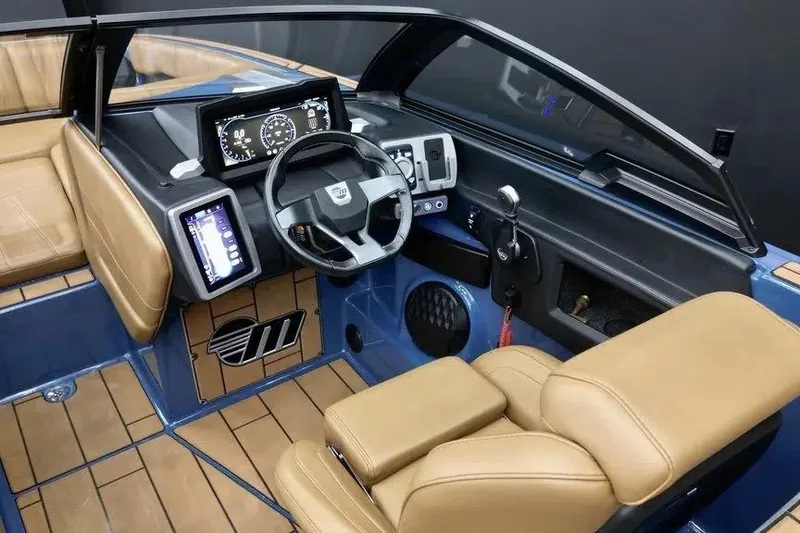Slide: The Image of 2024 Malibu Wakesetter 24 MXZ interior with modern dashboard and tan seating. - 6