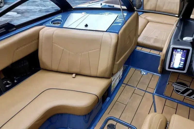 Slide: The Image of 2024 Malibu Wakesetter 24 MXZ interior with tan leather seats and modern dashboard. - 7