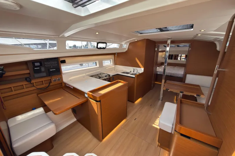 Slide: The Image of Interior of 2025 Jeanneau Sun Odyssey 440 yacht, featuring modern wood finishes and spacious layout. - 26