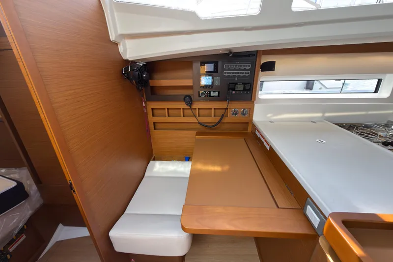 Slide: The Image of 2025 Jeanneau Sun Odyssey 440 interior with navigation station and wooden cabinetry. - 29