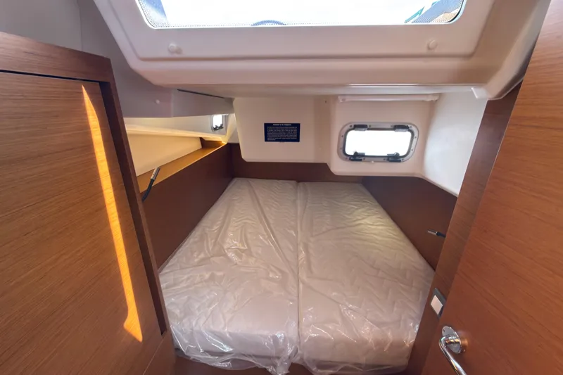 Slide: The Image of Cabin interior of 2025 Jeanneau Sun Odyssey 440 yacht with bed and window. - 30