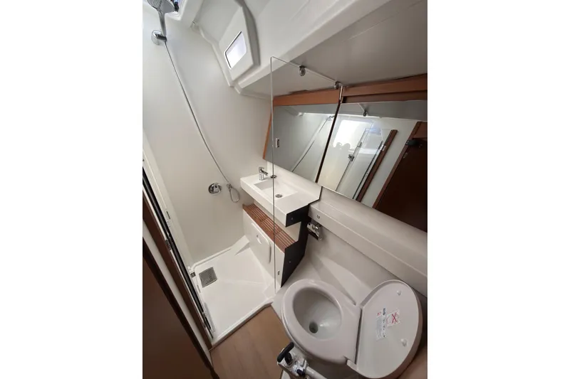 Slide: The Image of Modern bathroom in 2025 Jeanneau Sun Odyssey 440 yacht, featuring shower, sink, and toilet. - 33