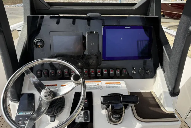 Slide: The Image of 2024 Yamaha Boats 255 FSH Sport E dashboard with steering wheel and digital displays. - 10