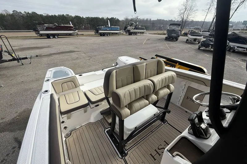 Slide: The Image of 2024 Yamaha Boats 255 FSH Sport E interior with seating and steering console. - 21