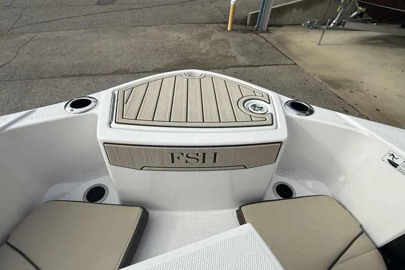 Slide: The Image of 2024 Yamaha Boats 255 FSH Sport E bow area with seating and cup holders. - 22