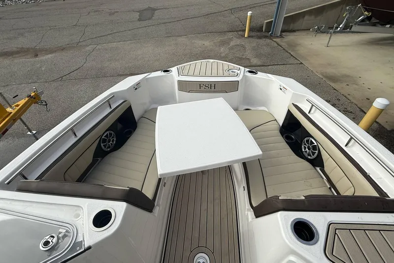 Slide: The Image of 2024 Yamaha Boats 255 FSH Sport E interior with seating and table setup. - 24