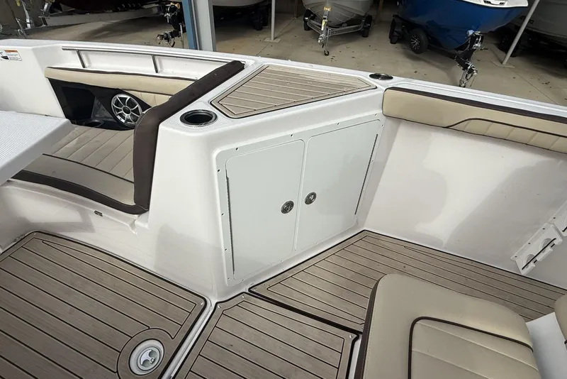 Slide: The Image of 2024 Yamaha Boats 255 FSH Sport E interior with seating and storage compartments. - 25