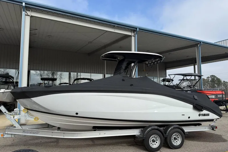 Slide: The Image of 2024 Yamaha Boats 255 FSH Sport E covered on trailer at dealership. - 26