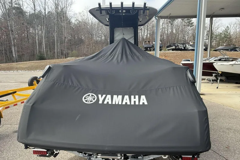 Slide: The Image of 2024 Yamaha Boats 255 FSH Sport E covered, parked outdoors on a trailer. - 27