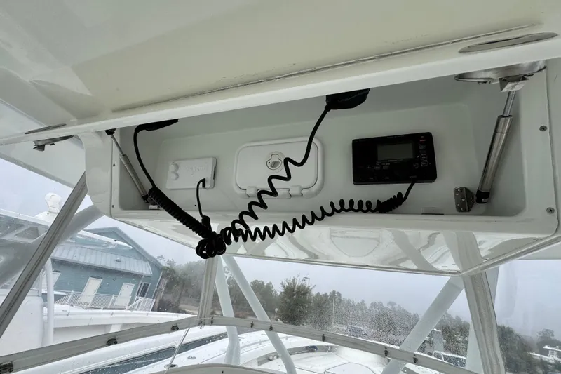 Slide: The Image of 2011 Yellowfin 42 Offshore boat console with electronic equipment and storage compartment. - 11