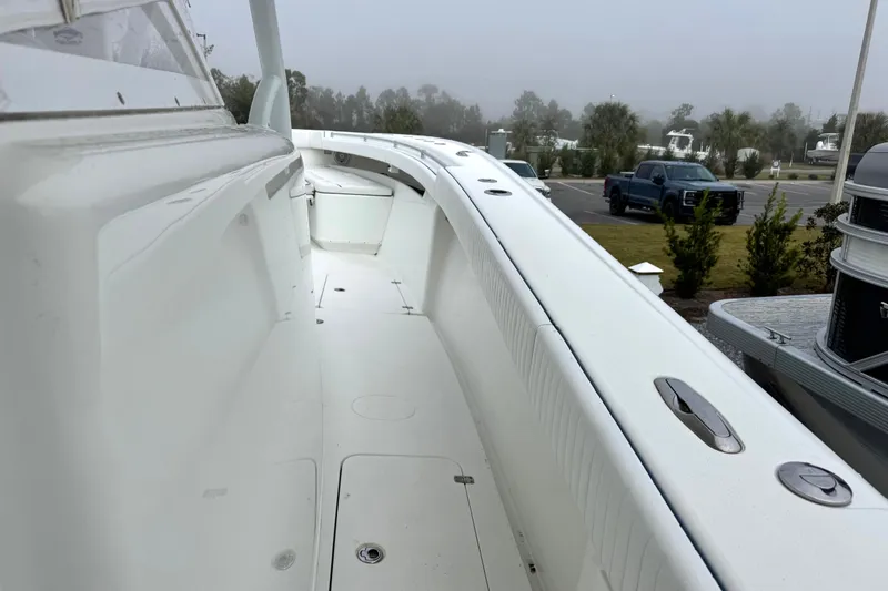 Slide: The Image of 2011 Yellowfin 42 Offshore boat deck with sleek white design and spacious layout. - 12