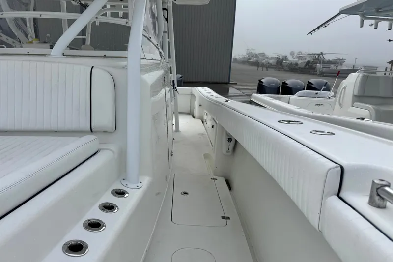 Slide: The Image of 2011 Yellowfin 42 Offshore boat interior with white seating and rod holders. - 16