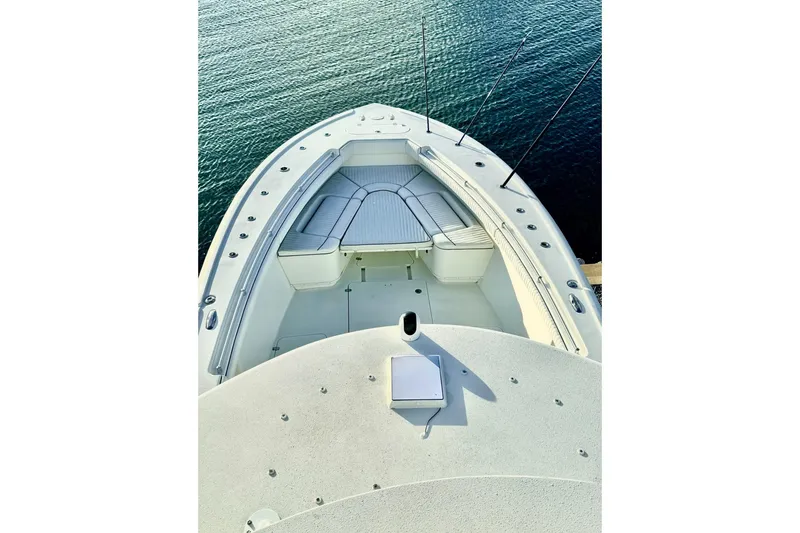 Slide: The Image of 2011 Yellowfin 42 Offshore boat deck with cushioned seating, overlooking calm water. - 20