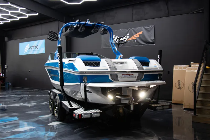 Slide: The Image of 2018 Nautique Super Air Nautique GS22 boat in showroom, rear view. - 13