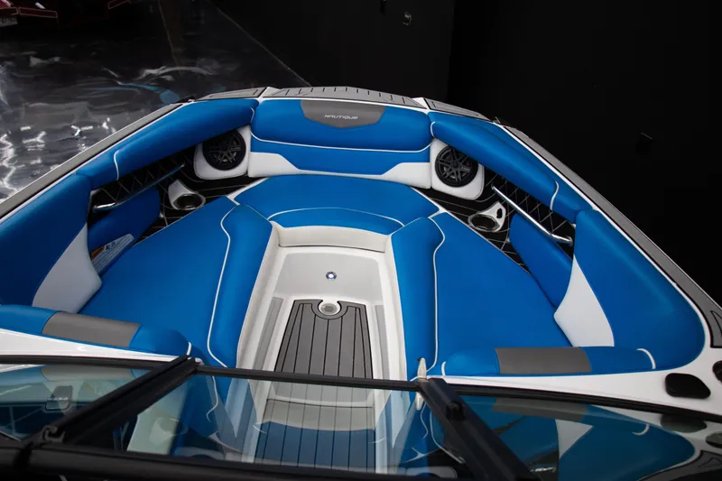Slide: The Image of 2018 Nautique Super Air Nautique GS22 boat interior with blue and white seating. - 5