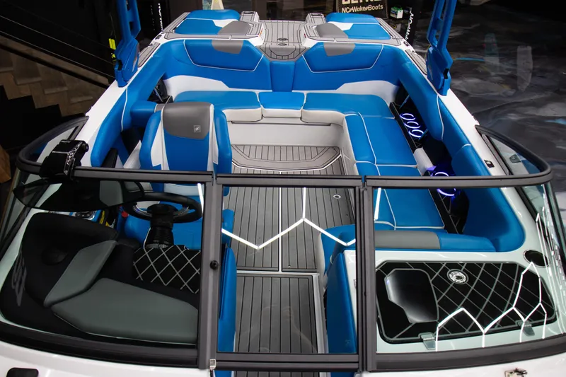 Slide: The Image of 2018 Nautique Super Air Nautique GS22 interior with blue and gray seating, modern design. - 6