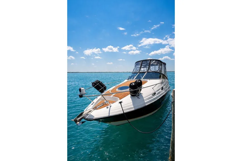 The Image of 2004 Regal Commodore 2665 boat docked on clear blue water under a sunny sky. - 0