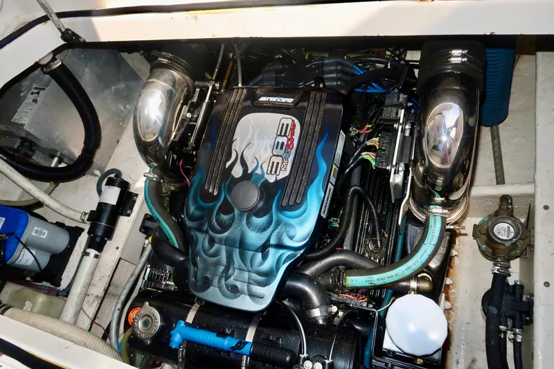 Slide: The Image of Engine compartment of a 2004 Regal 2665 Commodore boat, featuring a custom-painted engine cover. - 17