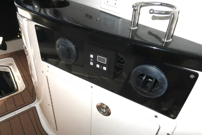 Slide: The Image of 2004 Regal 2665 Commodore boat interior with control panel and sink. - 9