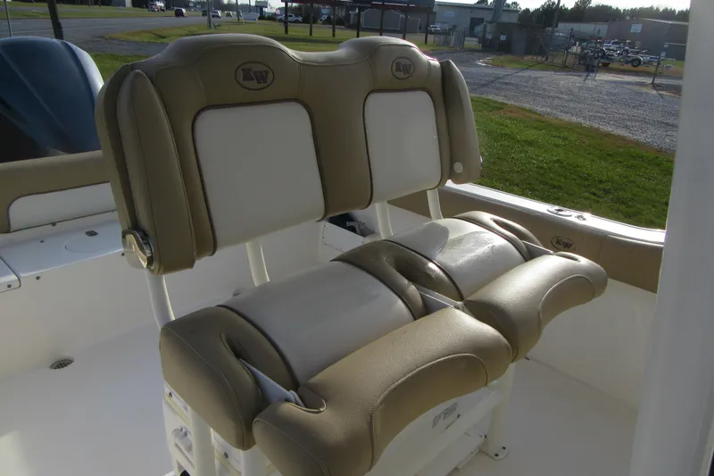 Slide: The Image of 2019 Key West 239 FS boat seats, beige and white, outdoor setting. - 15