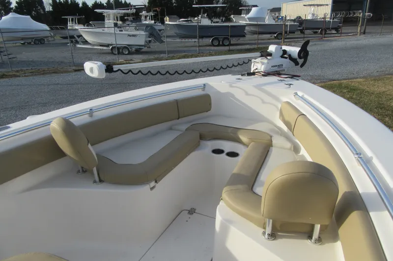 Slide: The Image of 2019 Key West 239 FS boat interior with beige seating and trolling motor. - 25