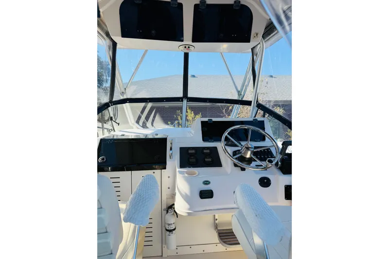 Slide: The Image of 2001 Grady-White Sailfish 282 boat cockpit with steering wheel and control panel. - 6