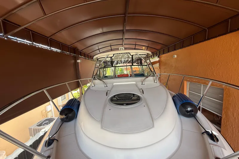 Slide: The Image of 2005 Seaswirl Striper 290 boat under a covered dock, featuring a sleek design. - 12