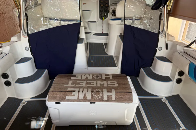Slide: The Image of 2005 Seaswirl Striper 290 boat interior with "Home Sweet Home" cooler, blue accents. - 17