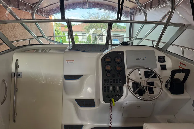 Slide: The Image of 2005 Seaswirl Striper 290 boat cockpit with Garmin navigation system and steering wheel. - 19