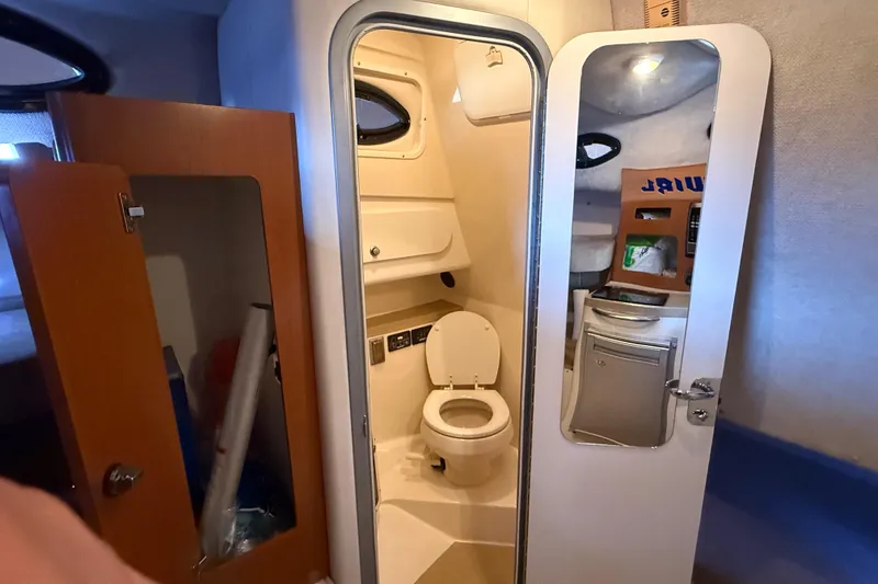 Slide: The Image of 2005 Seaswirl Striper 290 boat interior with compact bathroom and storage. - 26