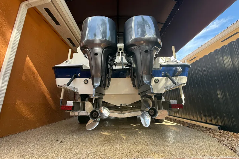 Slide: The Image of 2005 Seaswirl Striper 290 boat with dual outboard motors in a covered storage area. - 9