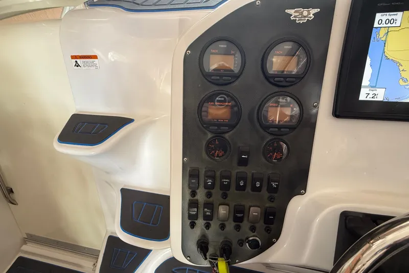 Slide: The Image of 2005 Seaswirl Striper 290 dashboard with gauges and navigation display. - 21