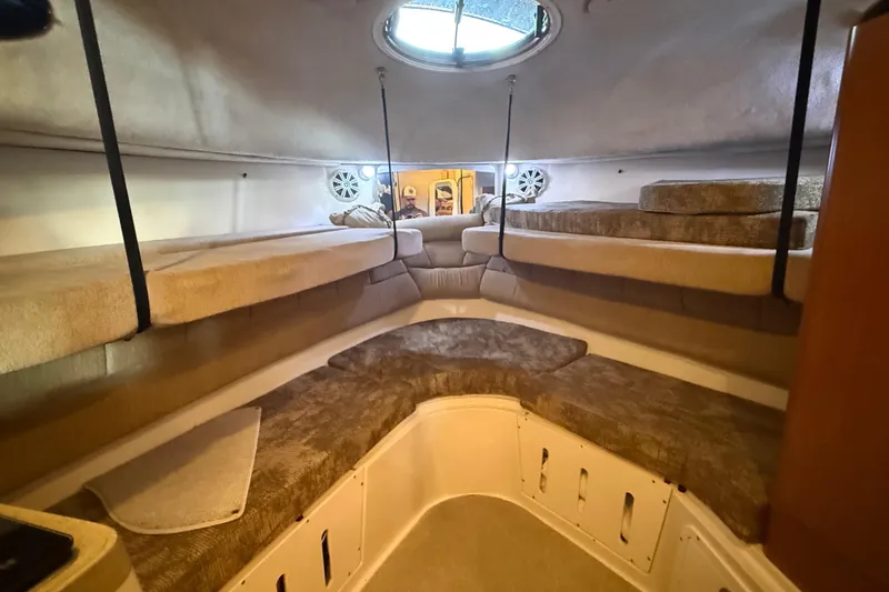 Slide: The Image of 2005 Seaswirl Striper 290 cabin interior with cozy seating and storage. - 29