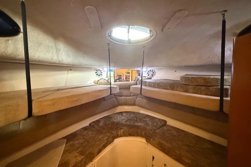 Slide: The Image of Interior cabin of 2005 Seaswirl Striper 290 boat with cozy seating and porthole. - 30