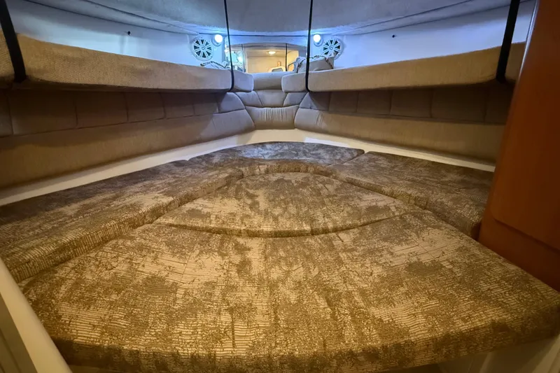 Slide: The Image of 2005 Seaswirl Striper 290 cabin interior with cushioned seating and ambient lighting. - 31