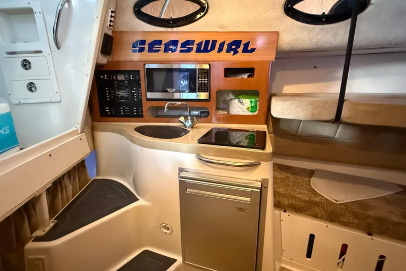 Slide: The Image of 2005 Seaswirl Striper 290 cabin interior with kitchenette and seating area. - 33
