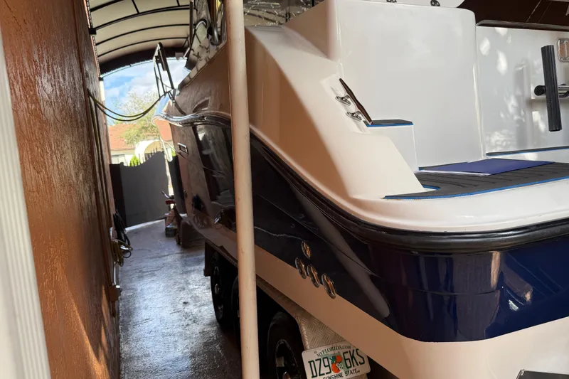 Slide: The Image of 2005 Seaswirl Striper 290 boat parked in a covered area, showcasing sleek design. - 6