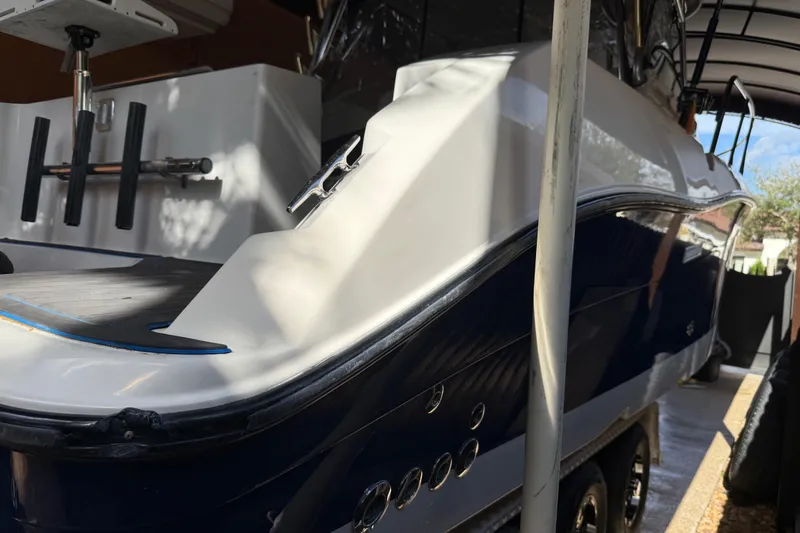 Slide: The Image of 2005 Seaswirl Striper 290 boat in storage, showcasing sleek design and fishing rod holders. - 7